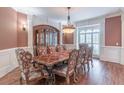 Elegant dining room displaying hardwood floors, ornate furniture, and natural light at 1584 Water Springs Way, Dacula, GA 30019