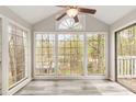 Sunroom with walls of windows overlooking a wooded area with vinyl floors and a ceiling fan at 204 Countryside Se Pl # 204, Smyrna, GA 30080