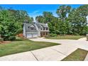 Charming home with a two-car garage, beautiful landscaping, and a spacious front yard at 40 Polo Xing, Hiram, GA 30141