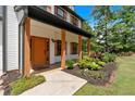 Inviting front porch with wooden columns and colorful landscaping at 40 Polo Xing, Hiram, GA 30141