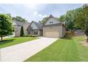 Charming two-story home with an attached two-car garage, showcasing the driveway and lawn at 4690 Hopewell Manor Dr, Cumming, GA 30028