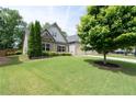 Charming two-story home featuring a well-manicured lawn and an attached two-car garage at 4690 Hopewell Manor Dr, Cumming, GA 30028