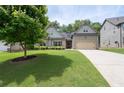 Charming two-story home featuring a well-manicured lawn and an attached two-car garage at 4690 Hopewell Manor Dr, Cumming, GA 30028