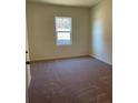Cozy carpeted bedroom with a view of a tree-lined landscape at 7785 Sudbury Cir, Covington, GA 30014