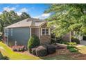 Home exterior featuring a well-manicured lawn and lush landscaping at 120 Laurel Rdg, Canton, GA 30114