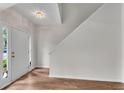 Bright foyer with hardwood floors, featuring front door and stairway at 621 Kenridge Way # 0, Suwanee, GA 30024