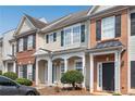 Charming townhome showcasing a well-maintained facade, neat landscaping, and welcoming front entrances at 621 Kenridge Way # 0, Suwanee, GA 30024