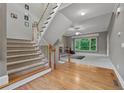 Carpeted staircase leading to a room with a fireplace and large picture window at 6217 Millstone Trl, Douglasville, GA 30135