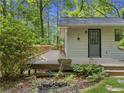 Home featuring deck, side entrance, stone steps, and rock lined flower garden at 6650 Bobby John Rd, Atlanta, GA 30349