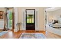 Inviting foyer with hardwood floors, decorative rug and front door with sidelights at 790 Sienna Dr, Cumming, GA 30040