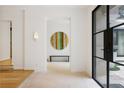 Bright foyer with hardwood floors, modern lighting, and a striking circular art piece at 1 Habersham Nw Way, Atlanta, GA 30305