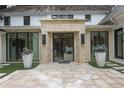 Stunning front entrance with a stone surround, modern black door, and manicured landscaping at 1 Habersham Nw Way, Atlanta, GA 30305