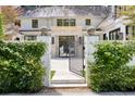 The property features a stone front gate with decorative accents and lush greenery at 1 Habersham Nw Way, Atlanta, GA 30305