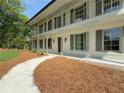 Charming two-story home with a painted brick exterior, a balcony, and a inviting walkway at 1892 Mercedes Ne Ct, Atlanta, GA 30345