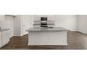 Bright kitchen featuring a center island, stainless appliances and white cabinetry at 25 Amberjack Trl, Covington, GA 30016