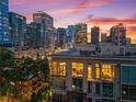 Modern city condo building with floor-to-ceiling windows showing lovely city skyline view at sunset at 905 Juniper Ne St # 808, Atlanta, GA 30309