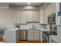 Updated kitchen with stainless steel appliances, granite countertops and tile backsplash at 130 26Th Nw St # 415, Atlanta, GA 30309