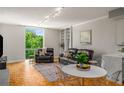 Cozy living room featuring natural light, hardwood floors, comfortable leather seating, and stylish decor at 130 26Th Nw St # 415, Atlanta, GA 30309