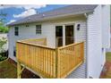 Backyard deck with wooden railing and vinyl siding on this home at 1645 Cobbs Creek Ln, Decatur, GA 30032