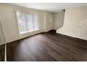 Bright living room featuring hardwood floors, large windows, and a neutral color palette at 1805 Ashborough Se Cir # H, Marietta, GA 30067