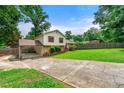 Exterior of a charming home with a covered carport, driveway and a spacious front yard at 273 Hardwood Ln, Lawrenceville, GA 30044