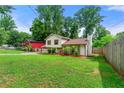 Exterior home showcasing its charming appeal with a spacious yard and mature trees at 273 Hardwood Ln, Lawrenceville, GA 30044