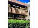 A condo with upper and lower balconies and brown wood railings, and green hedges at 401 Camelot Dr, Atlanta, GA 30349
