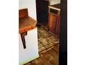 A damaged room with old, stained floor tiles and damage to the floor at 401 Camelot Dr, Atlanta, GA 30349