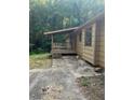 Back patio featuring ample space, a covered porch and a wooded lot at 618 Old Doss Dr, Canton, GA 30115