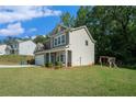 Spacious yard with a swing set, perfect for outdoor play and relaxation, complementing the charming two-story home at 741 Jackson Ct, Social Circle, GA 30025
