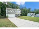 A charming two-story home with a long driveway and ample green space, perfect for outdoor activities and relaxation at 741 Jackson Ct, Social Circle, GA 30025