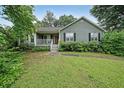 Traditional home with a cozy front porch and a well-maintained green lawn at 251 Lambeth Dr, Hiram, GA 30141