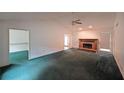 Spacious living room featuring a brick fireplace and lots of natural light at 251 Lambeth Dr, Hiram, GA 30141