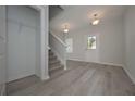 Bright entryway with hardwood floors, staircase, and coat closet, offering a warm welcome at 48 Beaver Pt, Villa Rica, GA 30180