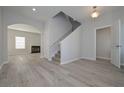 Inviting foyer with hardwood floors, staircase, neutral color scheme, and seamless transition to other living spaces at 48 Beaver Pt, Villa Rica, GA 30180