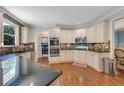 Well-equipped kitchen boasting granite countertops, stainless steel appliances, and ample cabinet space at 6009 Castleton Mnr, Cumming, GA 30041