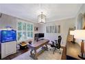 Charming office with a large window, custom light fixture, and a beautiful, decorative accent wall at 6009 Castleton Mnr, Cumming, GA 30041