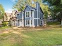 Inviting two-story home featuring blue siding, white trim windows, and a well-manicured front lawn at 845 Heritage Dr, Stone Mountain, GA 30088