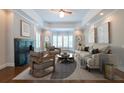 Comfortable living room with hardwood floors, fireplace, tray ceiling, bay window, and ample seating at 22 Mount Paran Rd, Atlanta, GA 30327