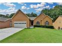 Charming single-Gathering home with a well-manicured lawn and a two-car garage in a serene neighborhood at 2694 Sterling Dr, Lawrenceville, GA 30043