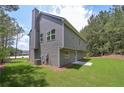 Exterior rear view of the home with the landscaped backyard and siding at 48 Deer Pl, Villa Rica, GA 30180