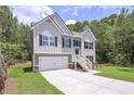 Charming two-story home featuring a two-car garage and inviting front porch at 48 Deer Pl, Villa Rica, GA 30180