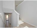Bright hallway features hardwood floors, access to the front door, and staircase leading to upper level at 48 Deer Pl, Villa Rica, GA 30180