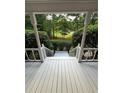 View from the porch overlooking the lush green yard and trees, providing a serene setting at 5142 Fawn Sw Ln, Conyers, GA 30094