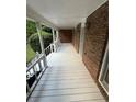 Spacious porch with brick accents, white railings, and ample space for outdoor seating at 5142 Fawn Sw Ln, Conyers, GA 30094