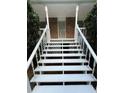 Close up of the front porch steps with white railings, offering a welcoming entry at 5142 Fawn Sw Ln, Conyers, GA 30094
