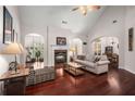 Bright living room with fireplace, archways, hardwood floors, and a vaulted ceiling at 7994 Larksview Dr, Fairburn, GA 30213