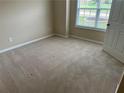 Neutrally painted bedroom with carpet, a window, and a closet door at 1266 Laurelwood Ct, Lawrenceville, GA 30045