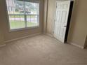 Cozy bedroom with neutral carpet, a window and a closet at 1266 Laurelwood Ct, Lawrenceville, GA 30045