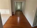 Foyer featuring hardwood flooring that leads to a carpeted room and the front door at 1266 Laurelwood Ct, Lawrenceville, GA 30045